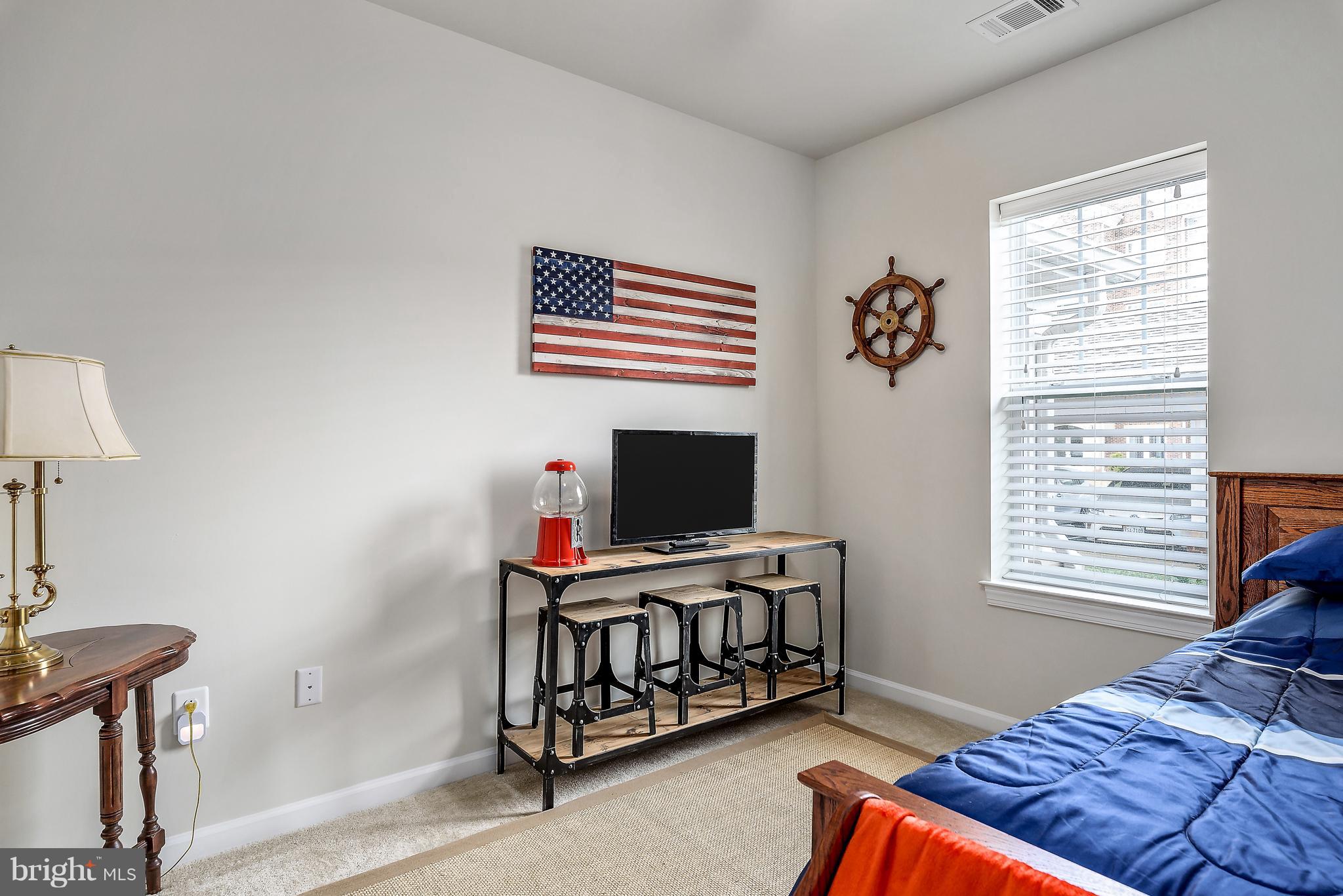 20650 Hope Spring Terrace, Unit 103 Ashburn, VA 20147 - Photo 18 of 30 a bedroom with furniture and a window