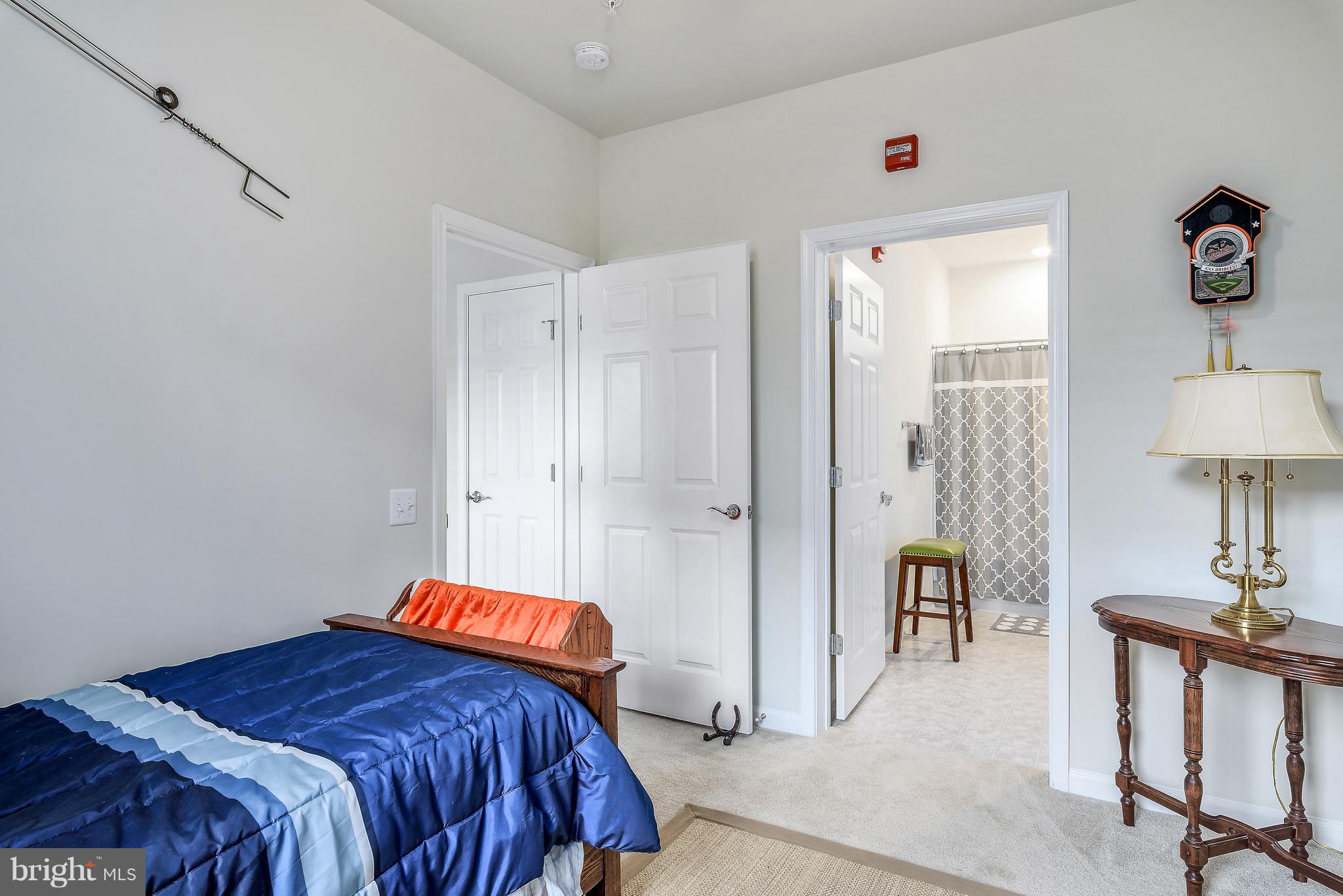 20650 Hope Spring Terrace, Unit 103 Ashburn, VA 20147 - Photo 19 of 30 a bedroom with a bed and a table in it