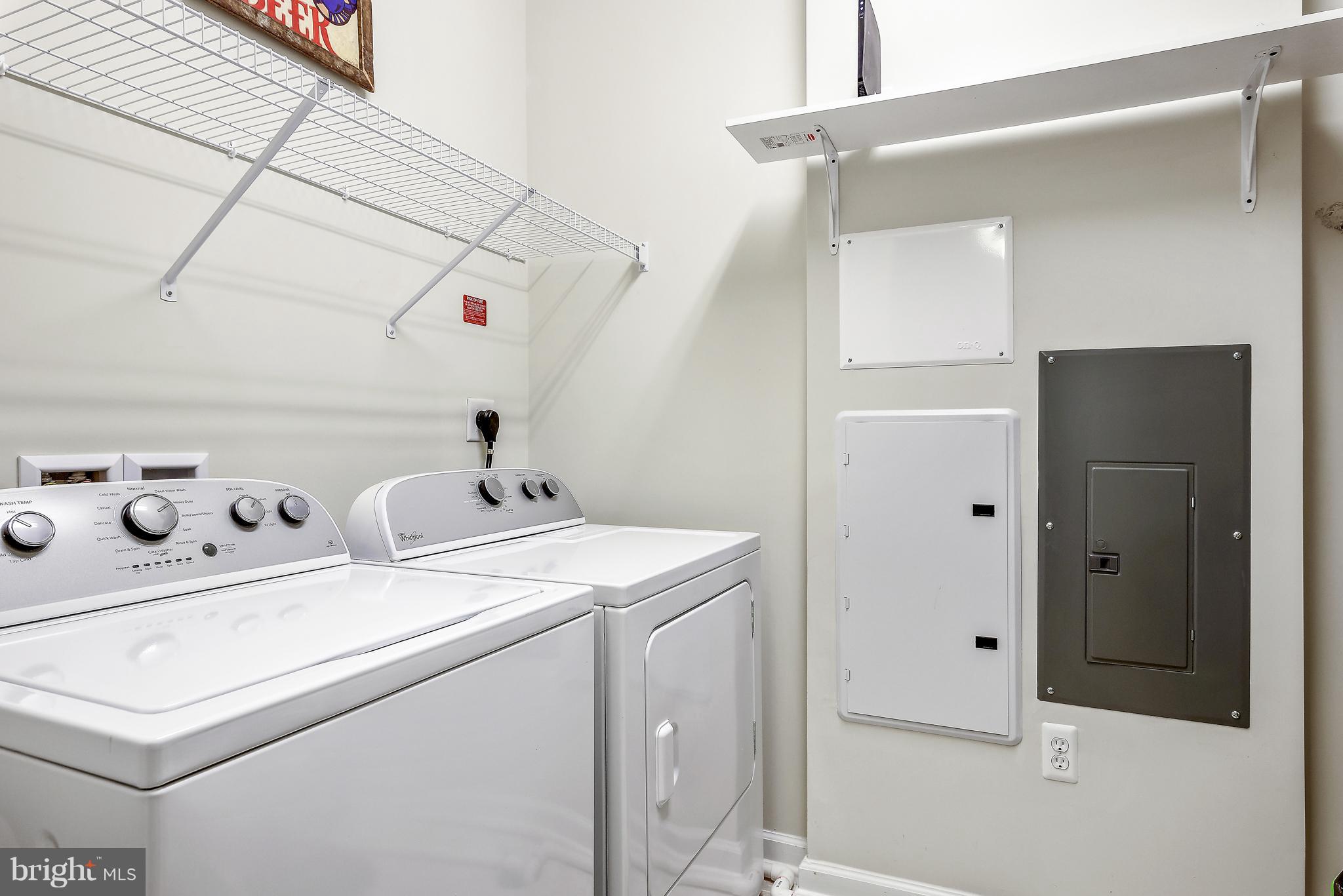 20650 Hope Spring Terrace, Unit 103 Ashburn, VA 20147 - Photo 21 of 30 a utility room with dryer and washer