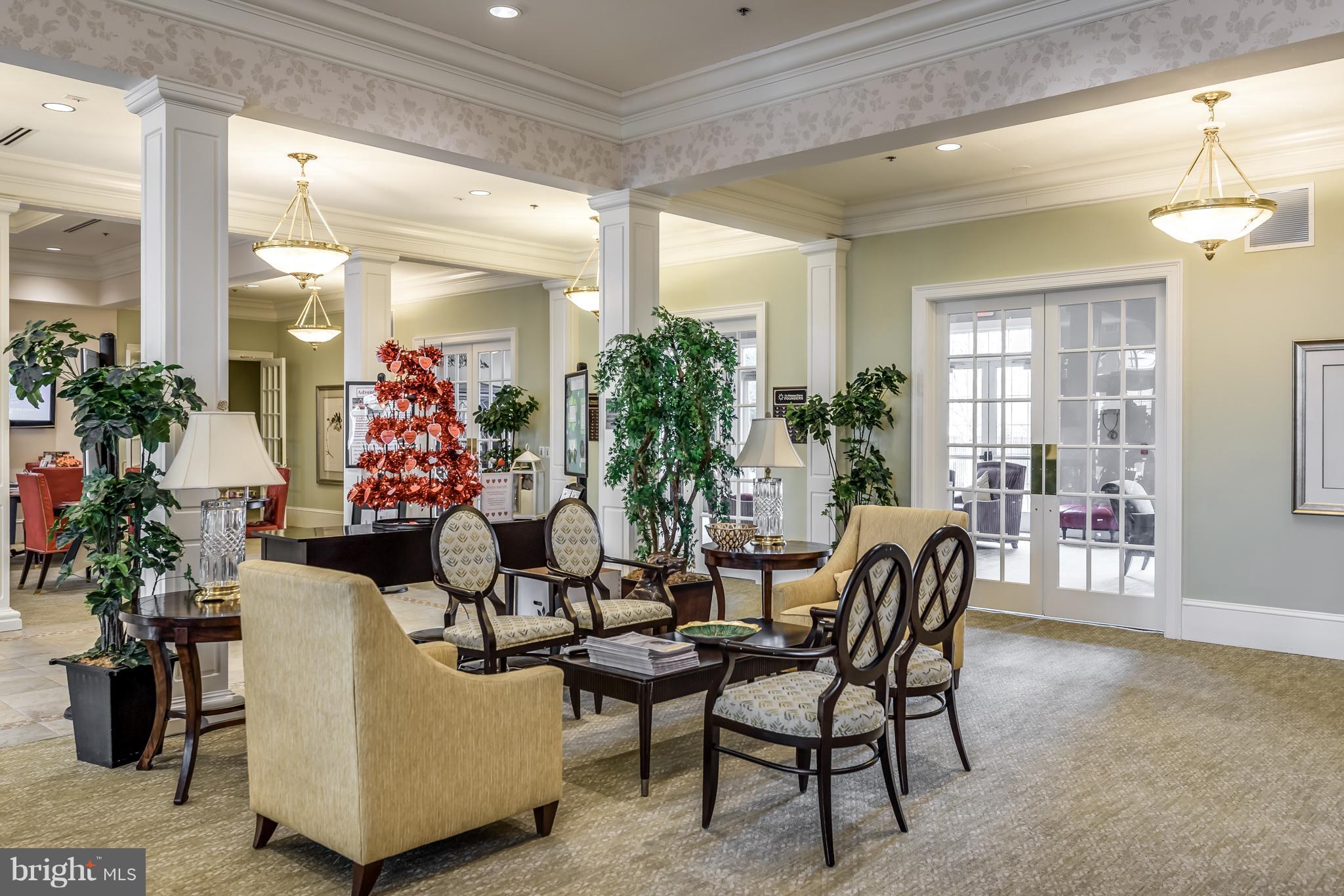 20650 Hope Spring Terrace, Unit 103 Ashburn, VA 20147 - Photo 27 of 30 a living room with furniture and a potted plant