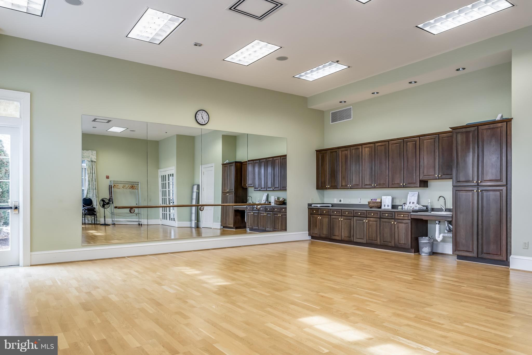 20650 Hope Spring Terrace, Unit 103 Ashburn, VA 20147 - Photo 30 of 30 a large kitchen with a large counter top stainless steel appliances and cabinets