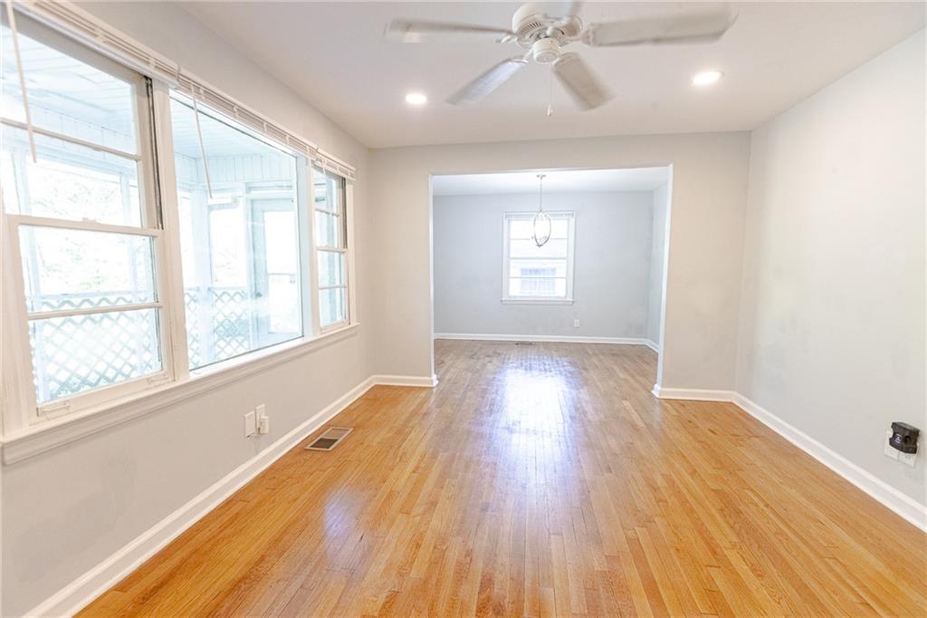 145 Holly Road Northwest Atlanta, GA 30314 - Photo 13 of 28 a view of an empty room with wooden floor and a window