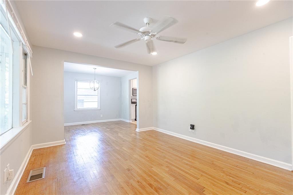 145 Holly Road Northwest Atlanta, GA 30314 - Photo 14 of 28 an empty room with wooden floor and windows