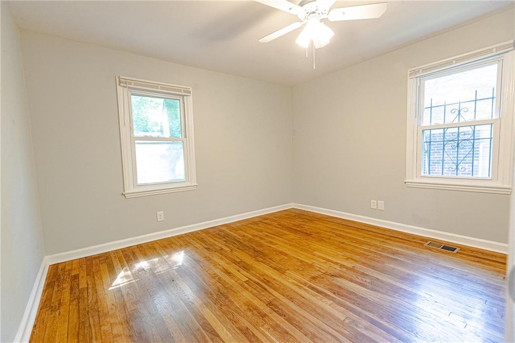 145 Holly Road Northwest Atlanta, GA 30314 - Photo 22 of 28 a view of empty room with wooden floor and fan