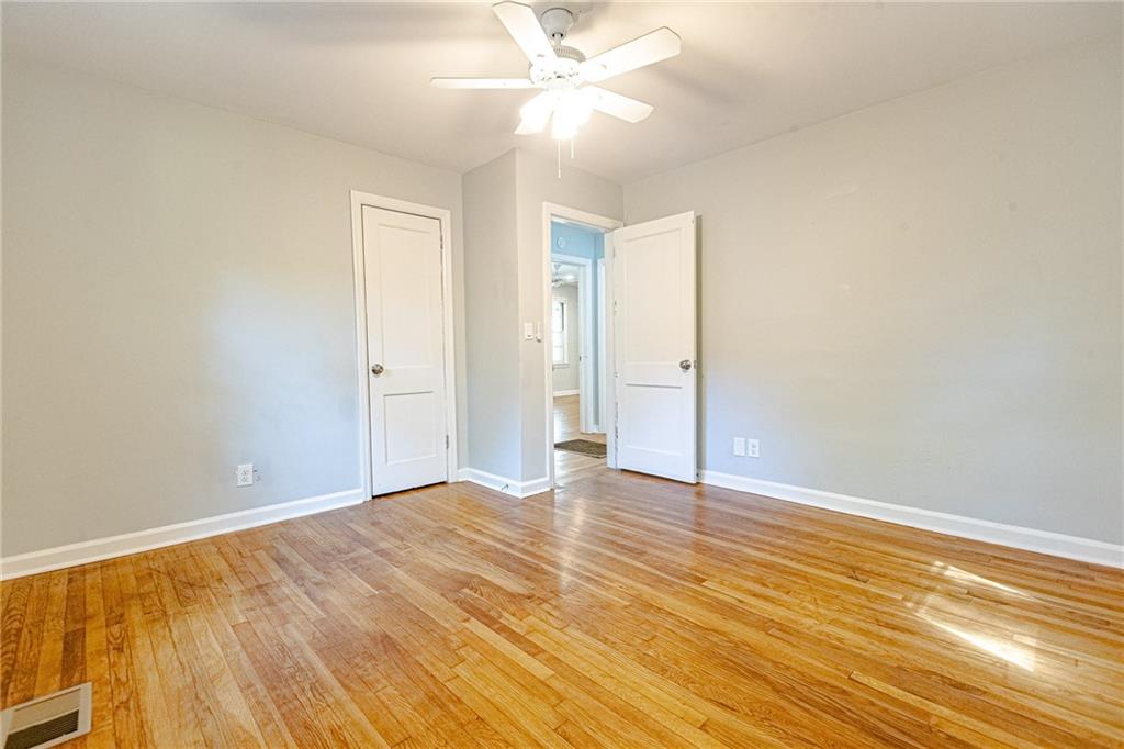 145 Holly Road Northwest Atlanta, GA 30314 - Photo 23 of 28 an empty room with wooden floor and windows