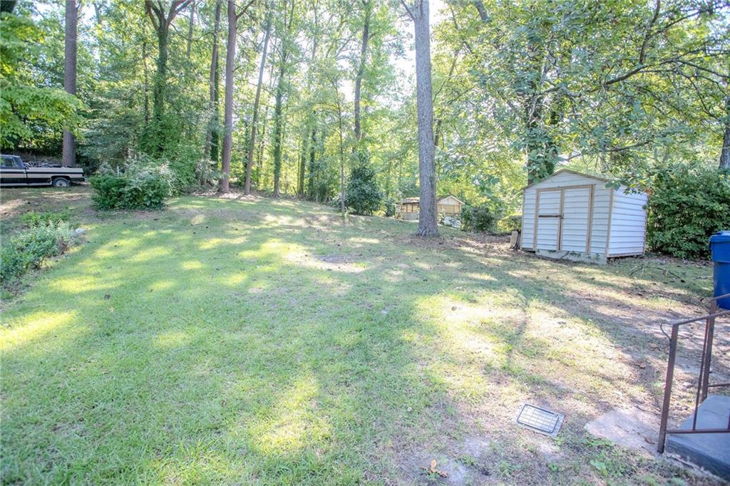145 Holly Road Northwest Atlanta, GA 30314 - Photo 27 of 28 a view of a backyard with large trees and plants