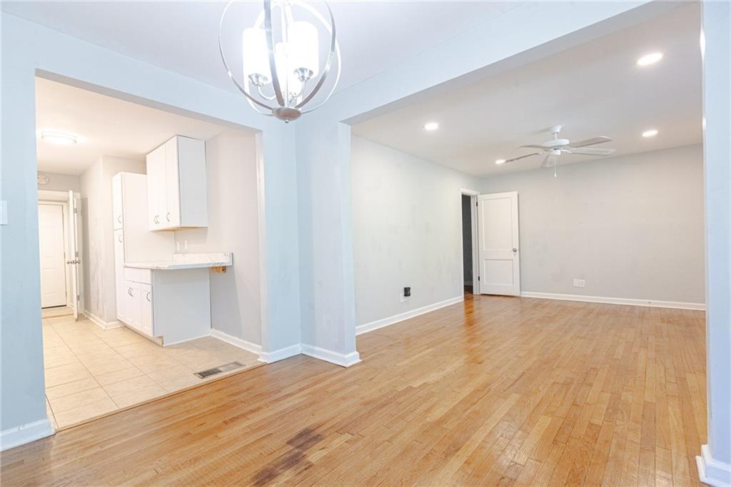145 Holly Road Northwest Atlanta, GA 30314 - Photo 10 of 28 a view of empty room with wooden floor and fan