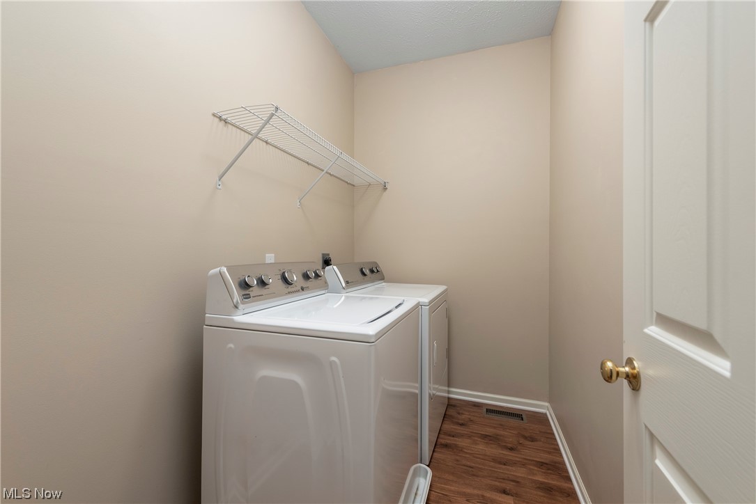 279 Sandstone Ridge Way Berea, OH 44017 - Photo 13 of 29 Clothes washing area with independent washer and dryer and dark hardwood floors