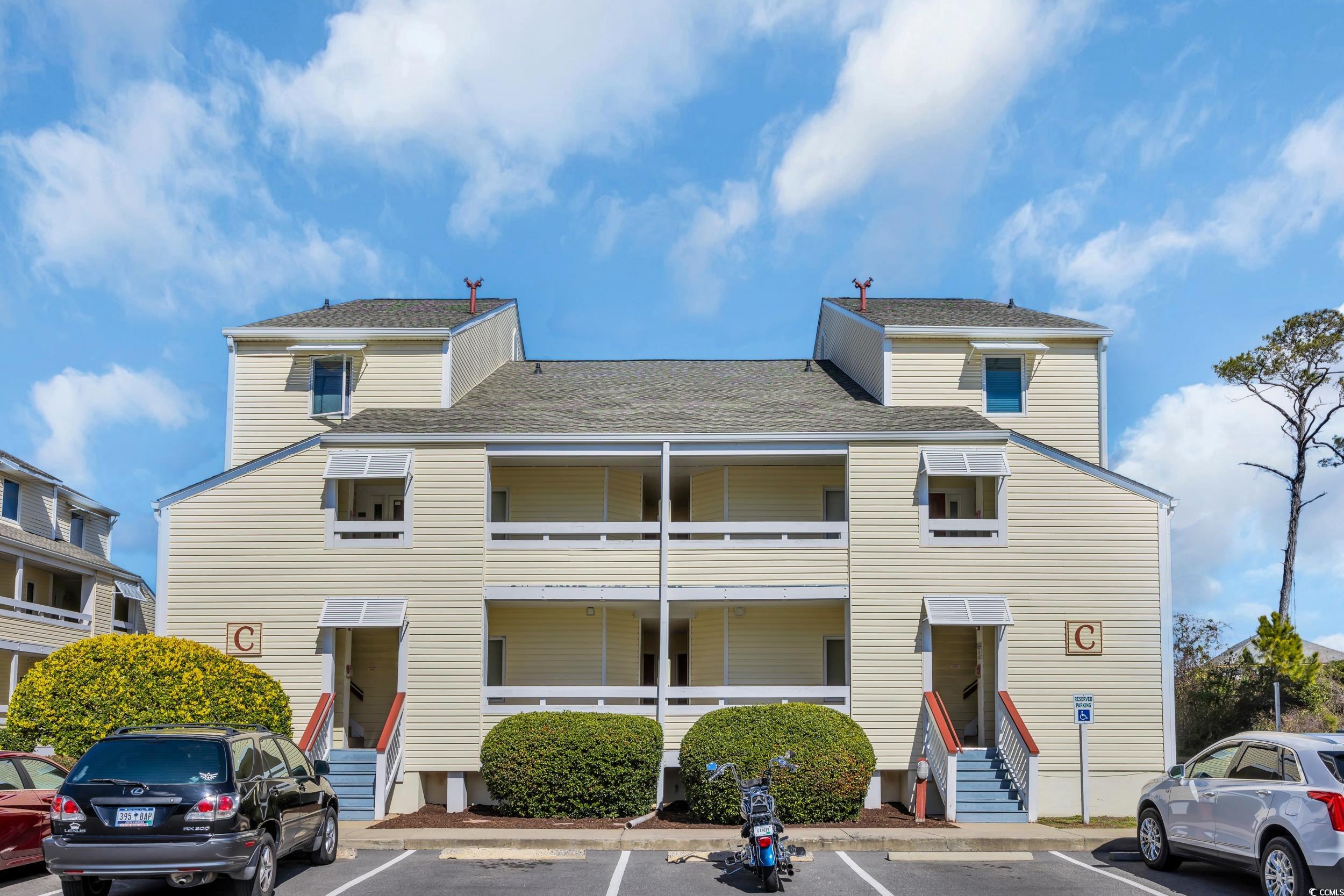 1100 Possum Trot Road, Unit C202 North Myrtle Beach, SC 29582 - Photo 1 of 34 View of building exterior featuring uncovered park