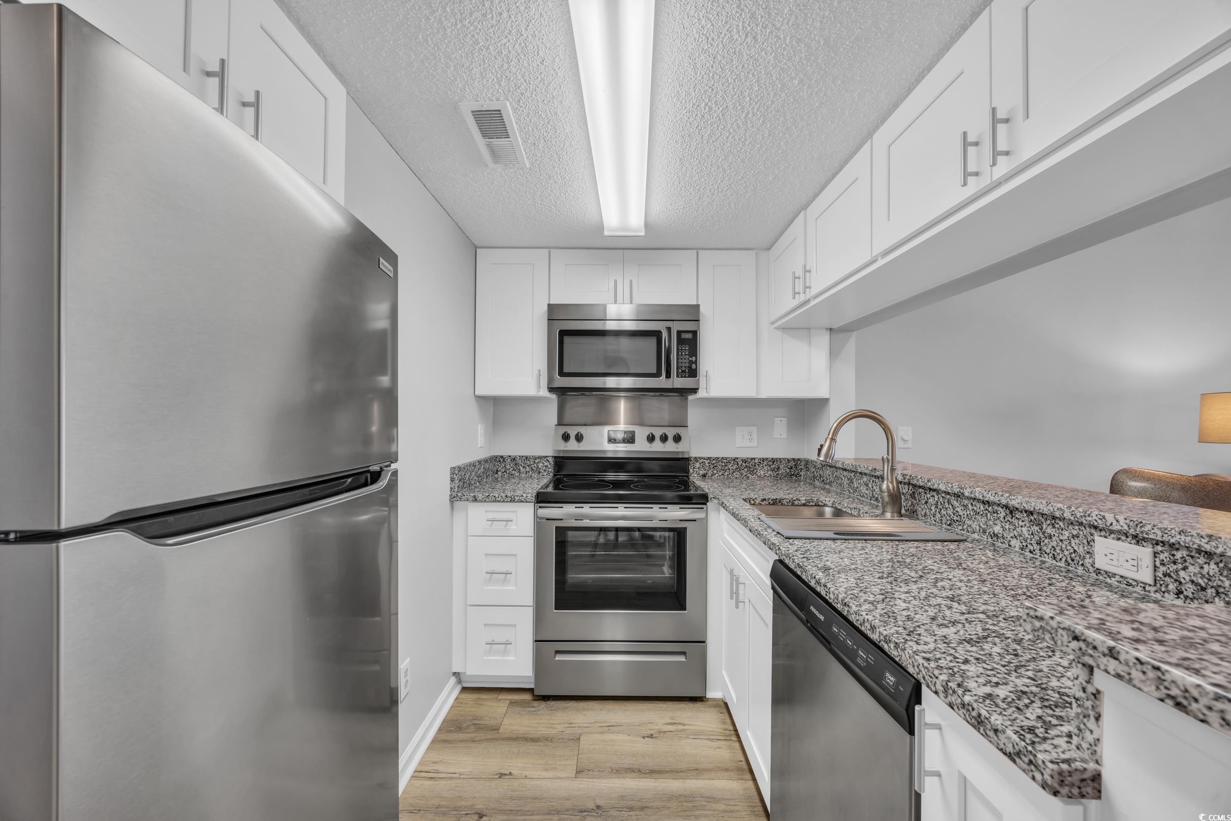 1100 Possum Trot Road, Unit C202 North Myrtle Beach, SC 29582 - Photo 13 of 34 Kitchen with stainless steel appliances, a sink, w