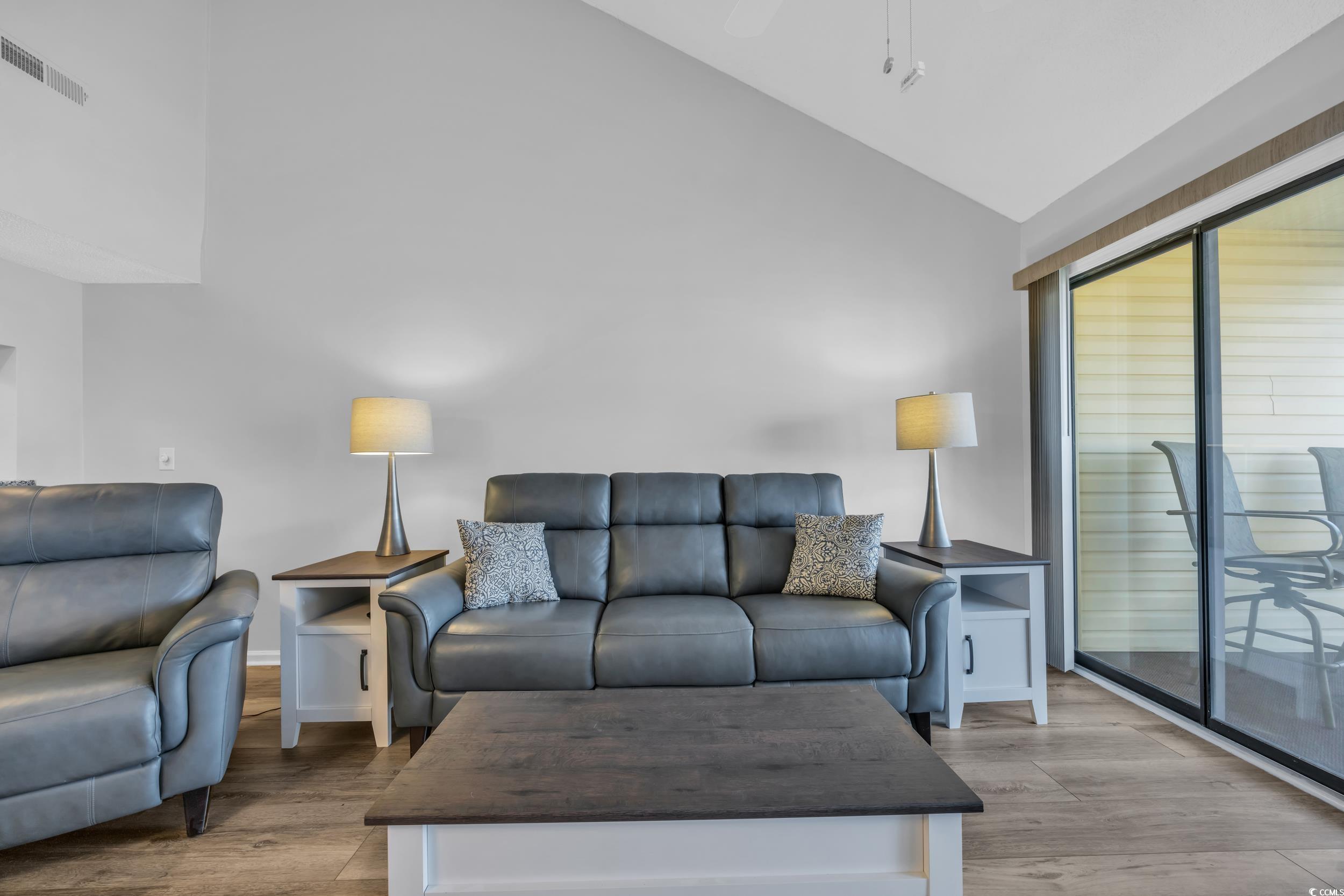 1100 Possum Trot Road, Unit C202 North Myrtle Beach, SC 29582 - Photo 15 of 34 Living room featuring high vaulted ceiling, basebo