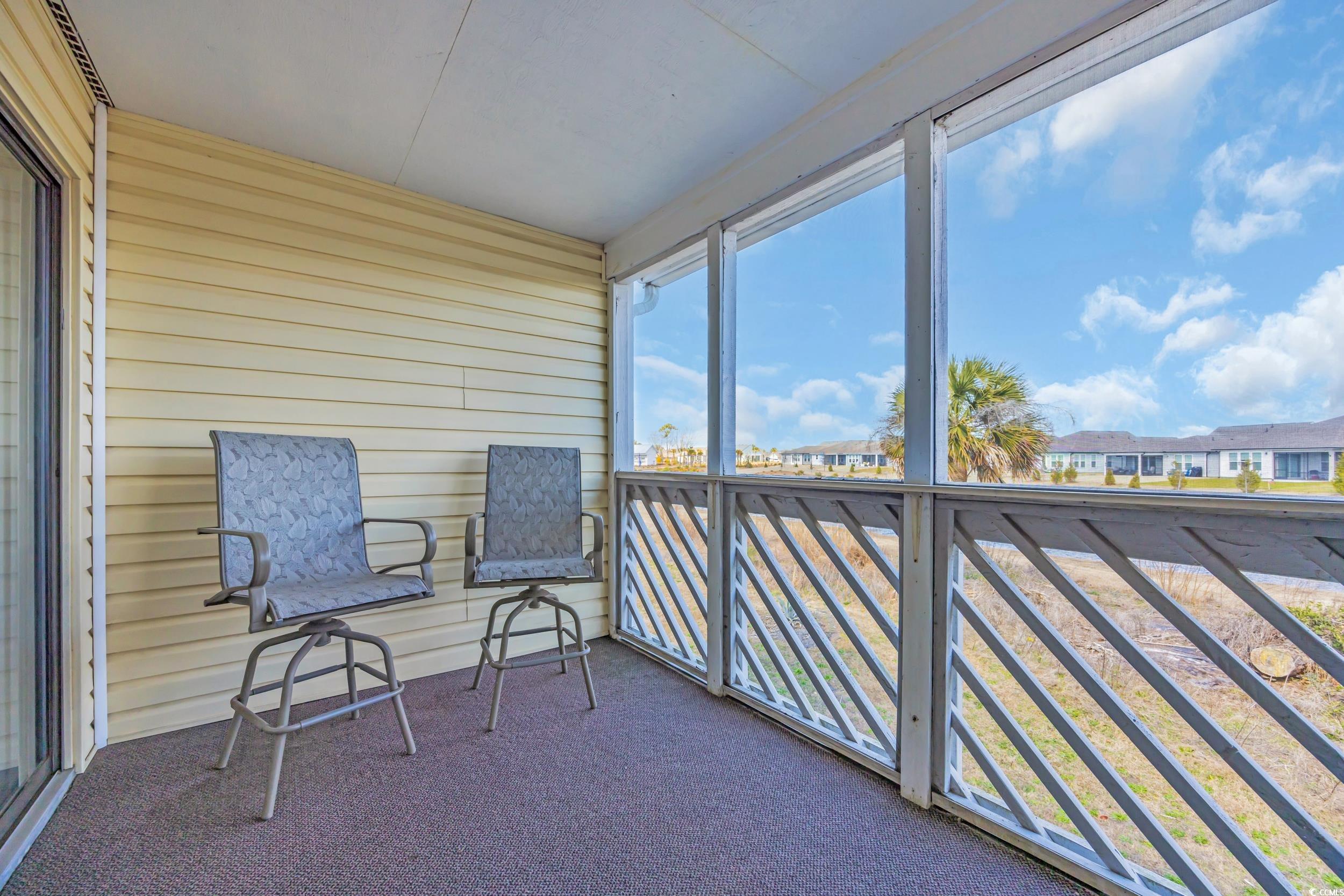 1100 Possum Trot Road, Unit C202 North Myrtle Beach, SC 29582 - Photo 19 of 34 Unfurnished sunroom featuring a residential view