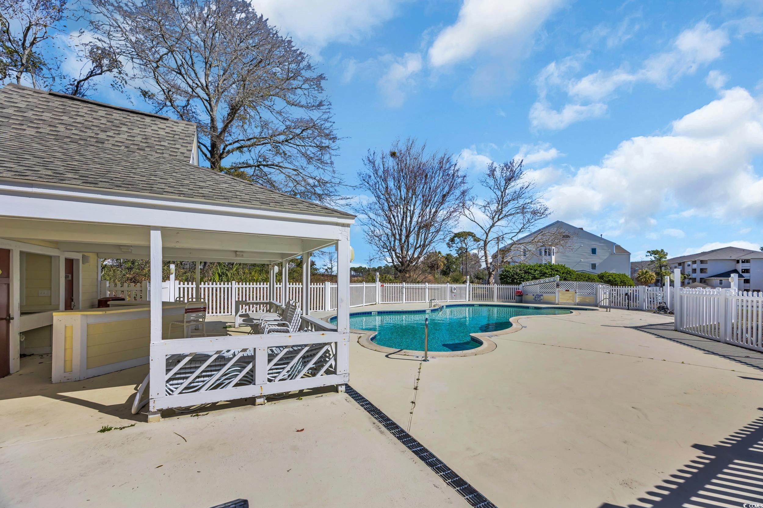 1100 Possum Trot Road, Unit C202 North Myrtle Beach, SC 29582 - Photo 21 of 34 Pool featuring a fenced backyard and a patio