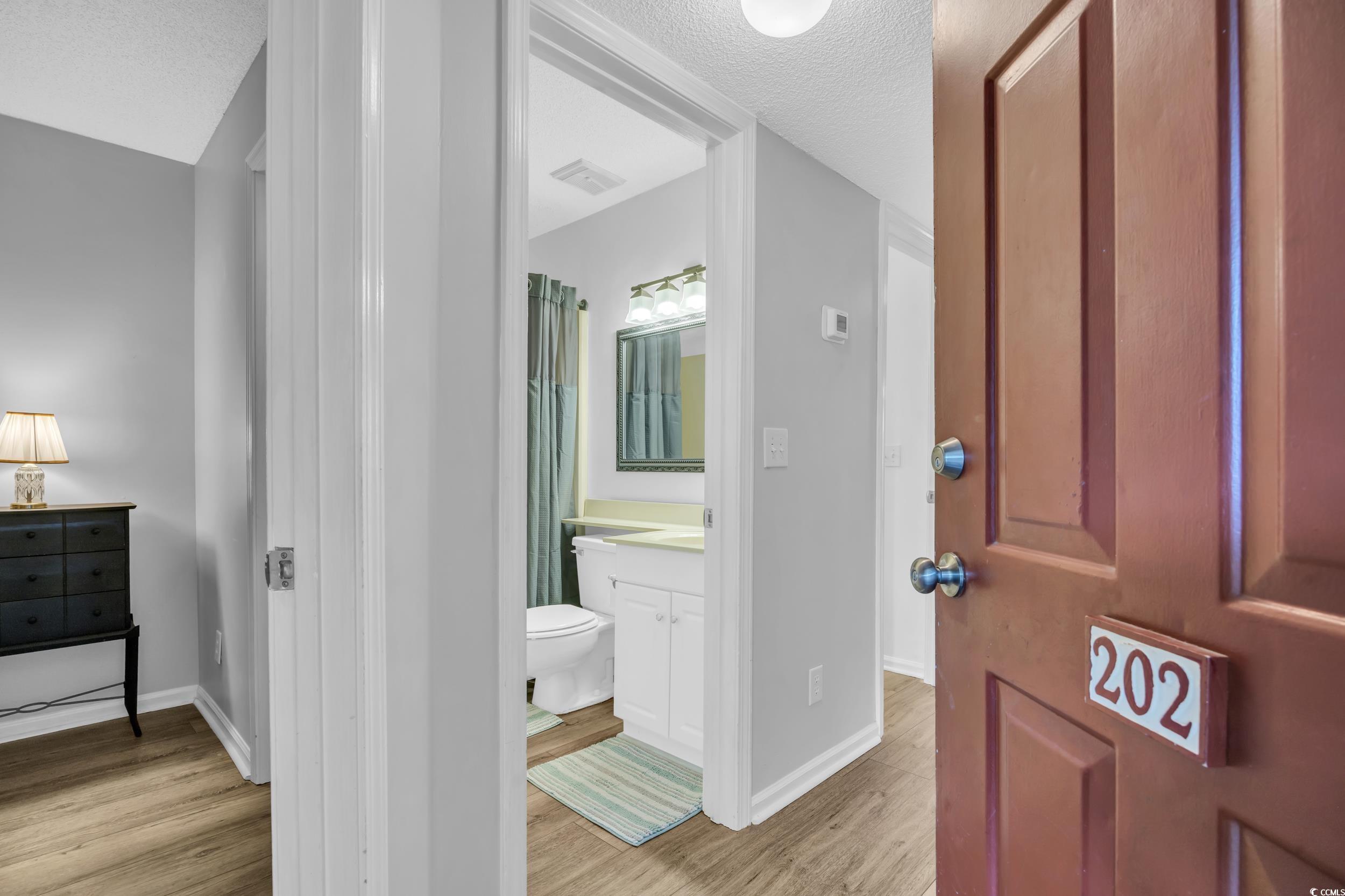 1100 Possum Trot Road, Unit C202 North Myrtle Beach, SC 29582 - Photo 6 of 34 Bathroom featuring visible vents, toilet, wood fin