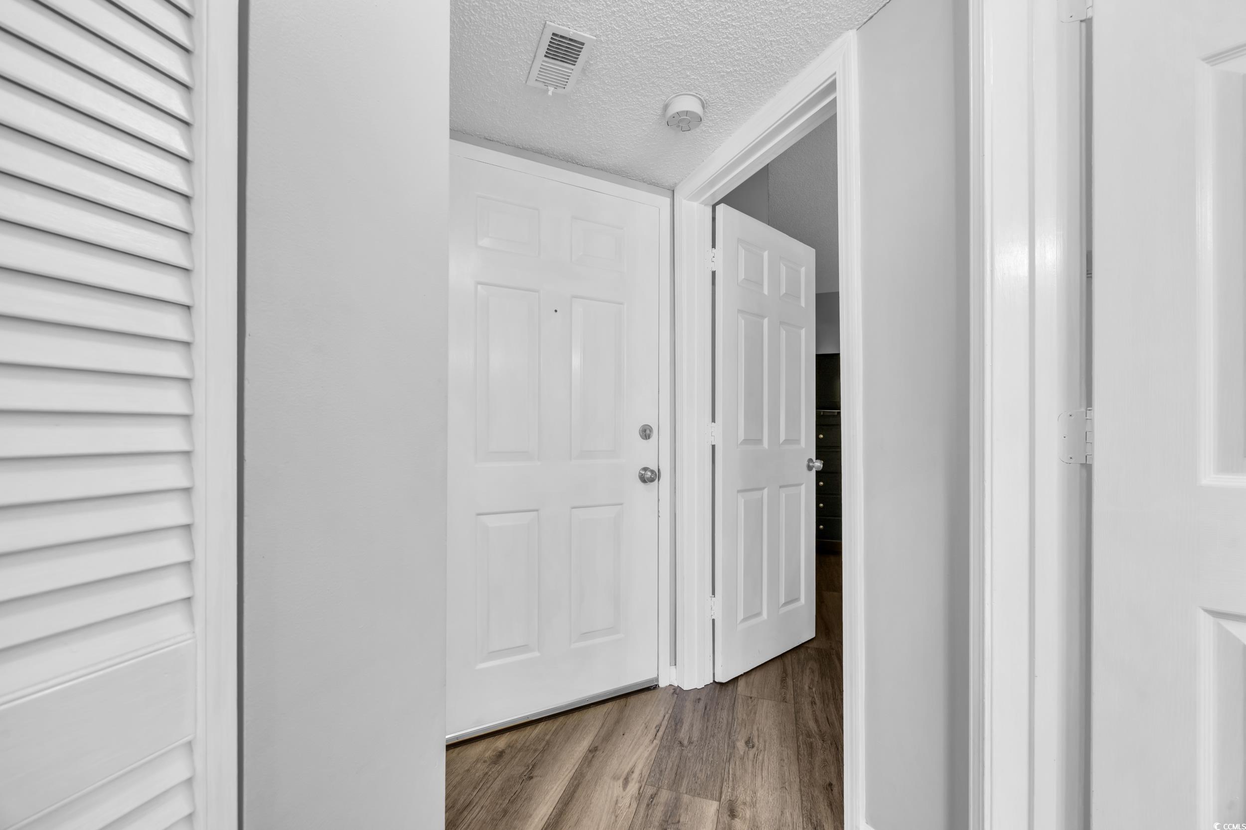 1100 Possum Trot Road, Unit C202 North Myrtle Beach, SC 29582 - Photo 7 of 34 Hall featuring visible vents, a textured ceiling,