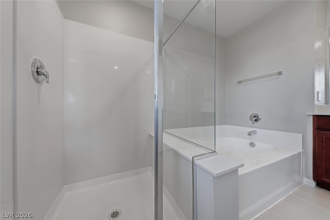 3564 Credere Lane Henderson, NV 89074 - Photo 21 of 40 Bathroom featuring vanity, a bath, a shower stall, and light tile patterned floors