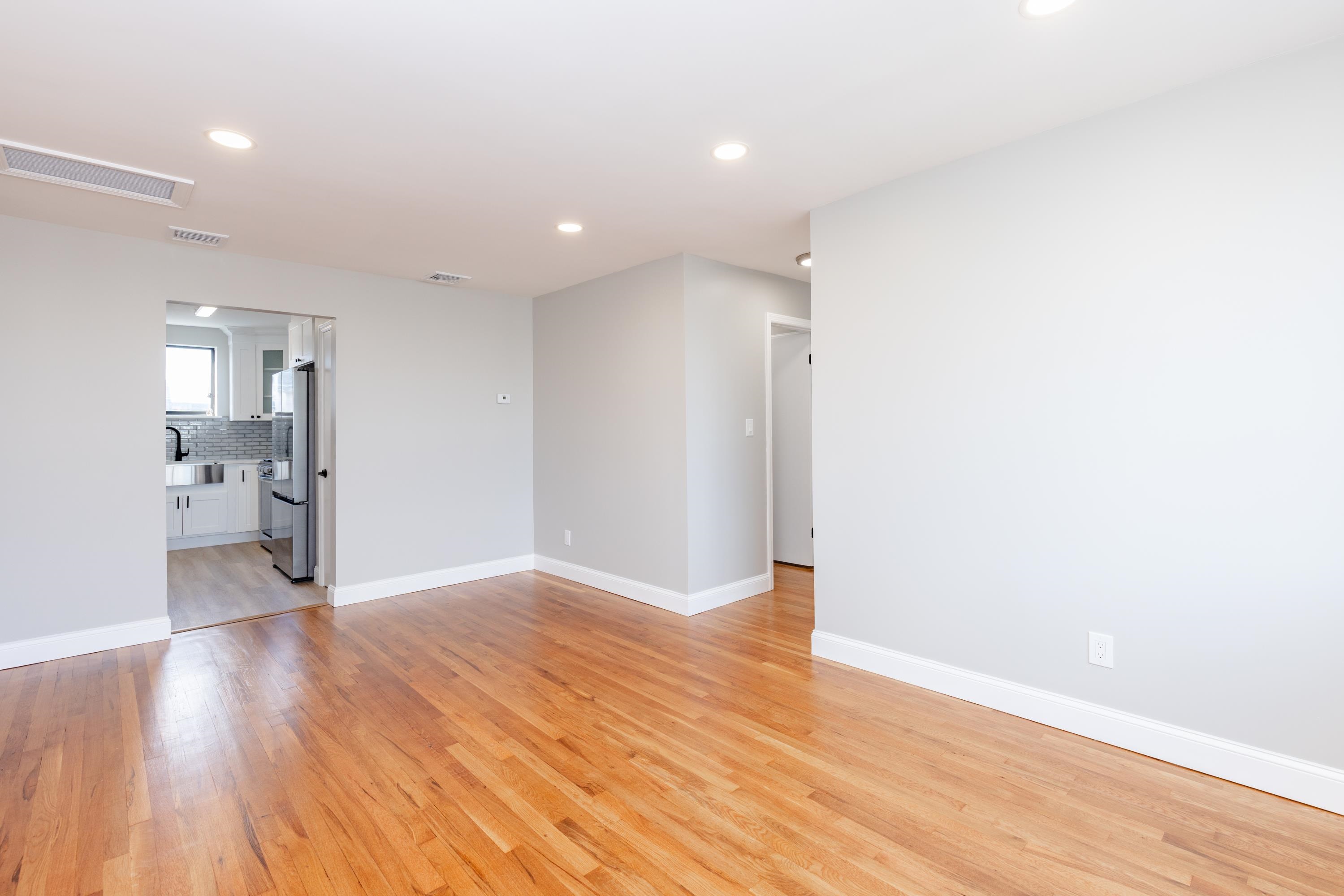 100 Lakeview Avenue, Unit 3A Clifton, NJ 07011 - Photo 7 of 13 a view of a room with wooden floor and a bathroom