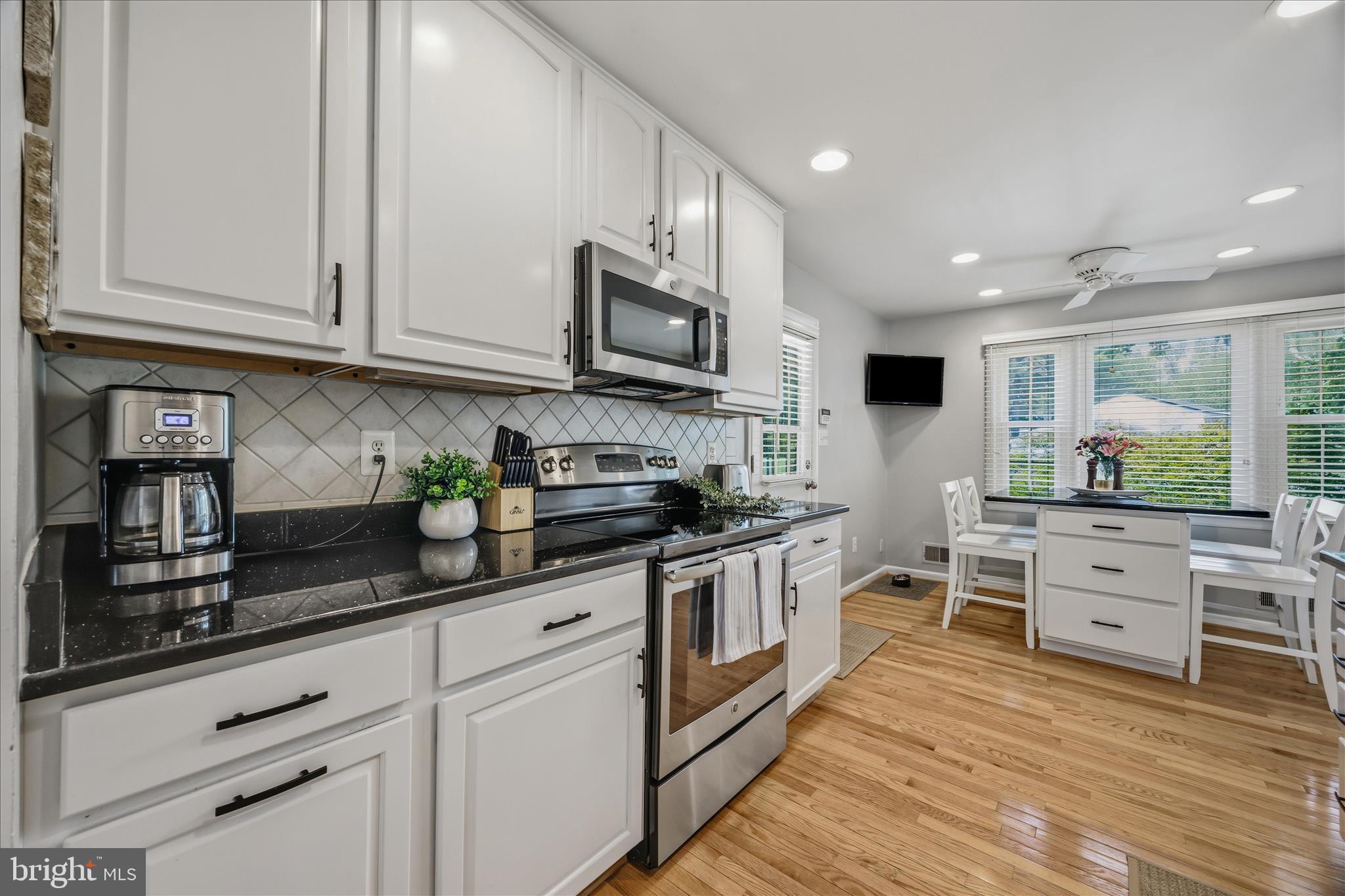 3204 Llewellyn Field Road Olney, MD 20832 - Photo 13 of 42 a kitchen with stainless steel appliances granite countertop a stove and cabinets