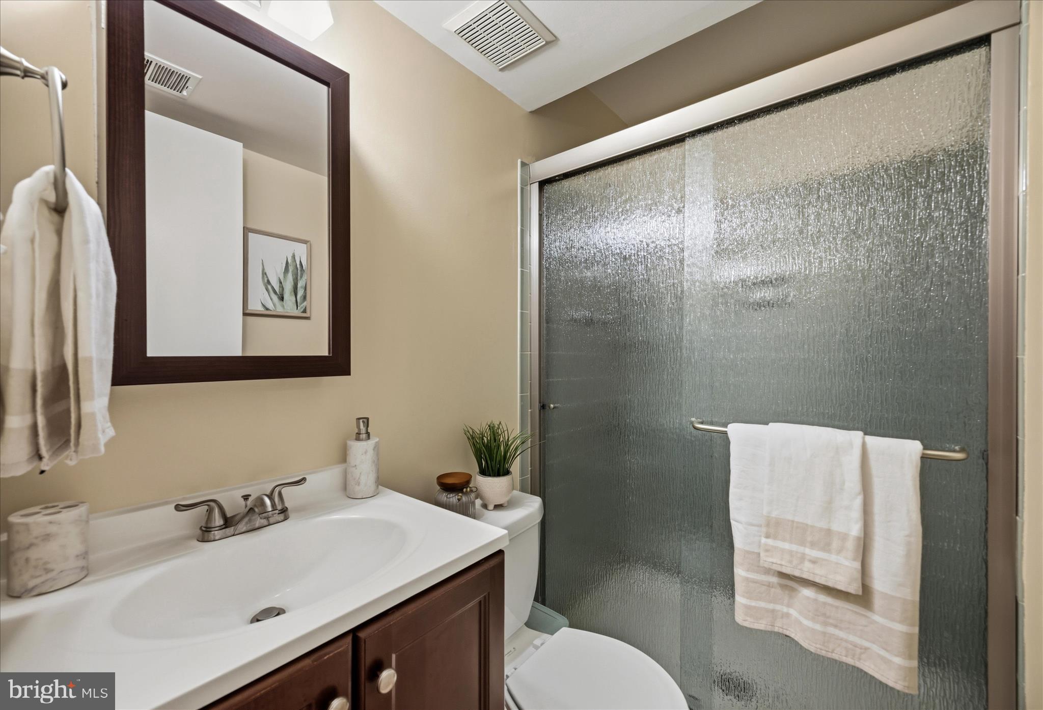 3204 Llewellyn Field Road Olney, MD 20832 - Photo 27 of 42 a bathroom with a sink vanity mirror and toilet