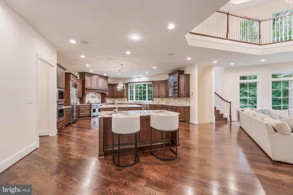 a living room with furniture and kitchen view
