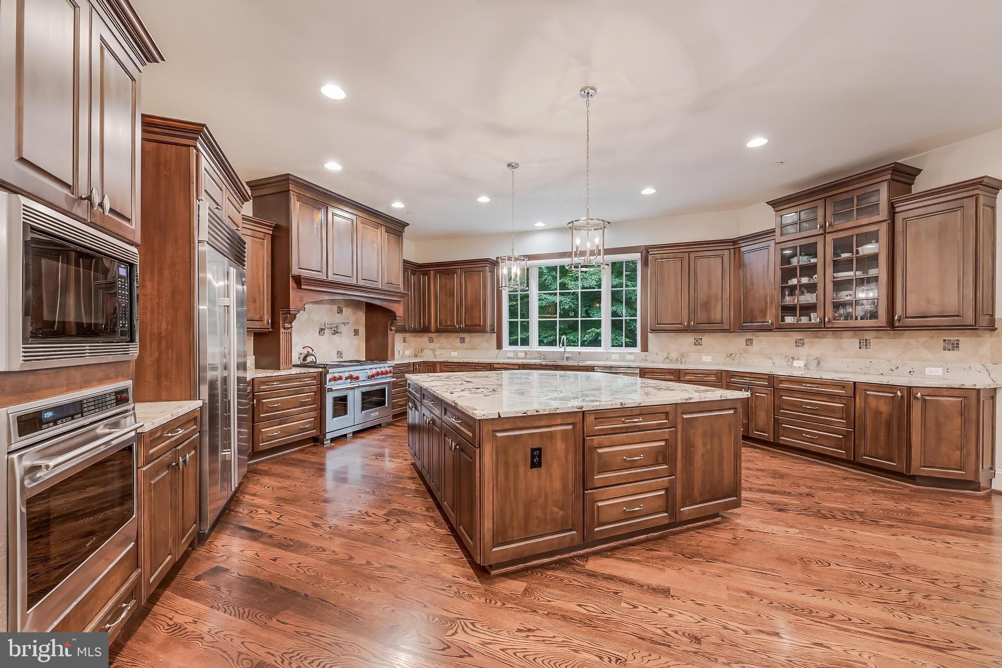 7020 Mountain Gate Drive Bethesda, MD 20817 - Photo 11 of 42 a kitchen with stainless steel appliances granite countertop a stove a sink and a refrigerator