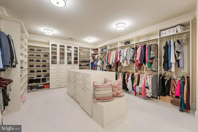 a view of walk in closet with clothes