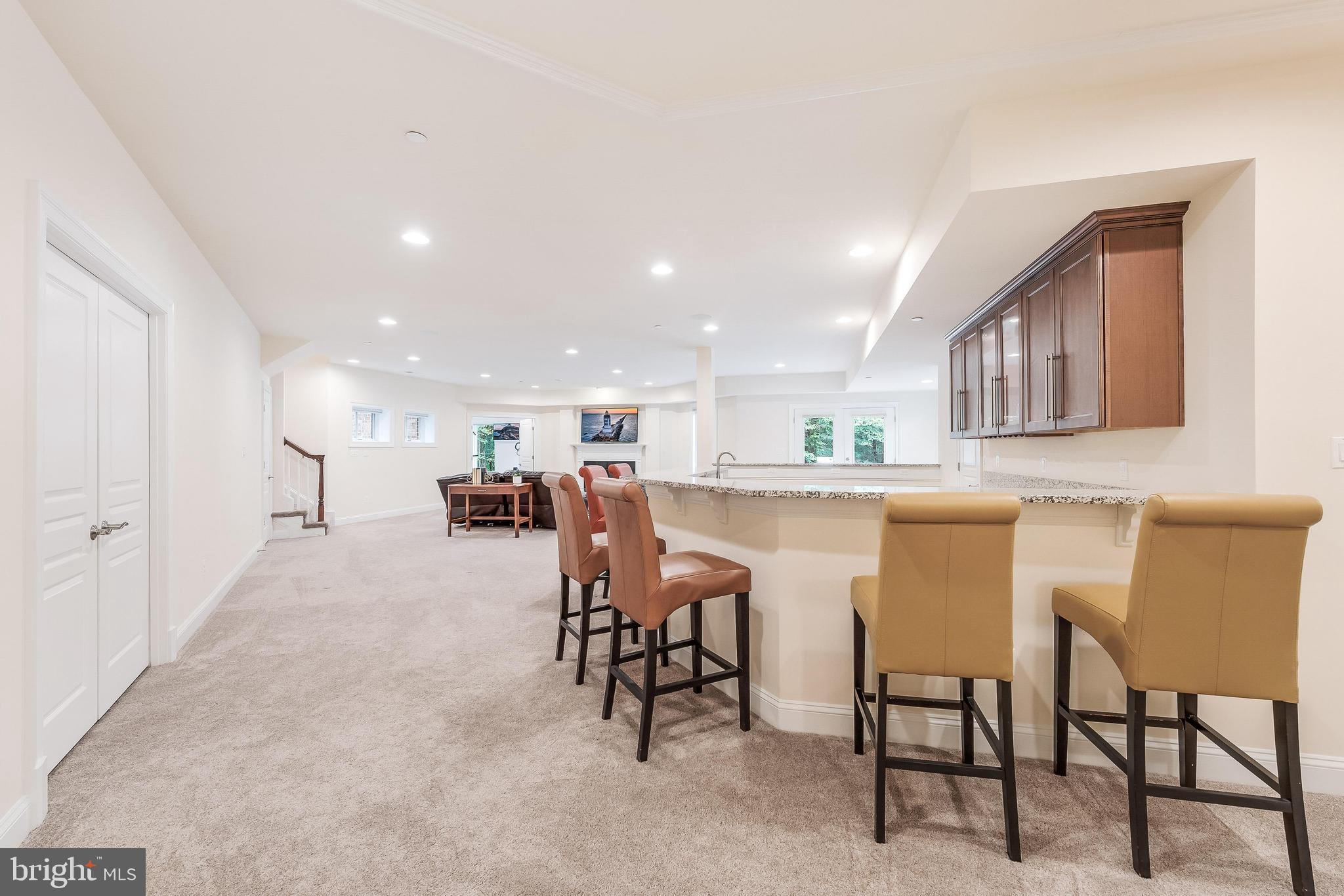 7020 Mountain Gate Drive Bethesda, MD 20817 - Photo 32 of 42 a dining hall with stainless steel appliances a dining table chairs and kitchen view