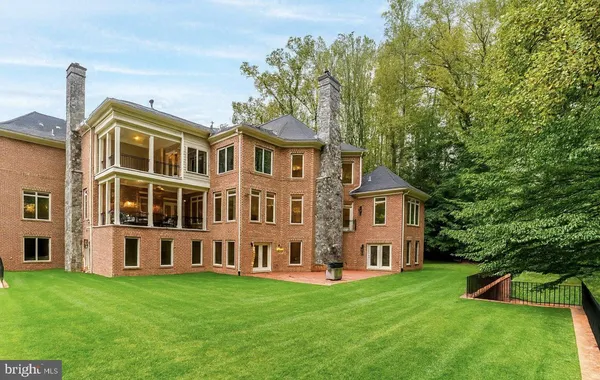a view of an house with backyard space and balcony