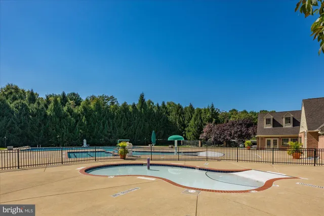 a view of a swimming pool with lounge chairs