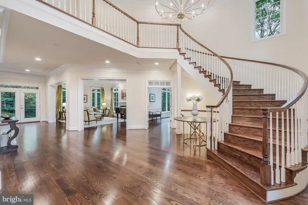 a view of interior of living room and hall with wooden floor