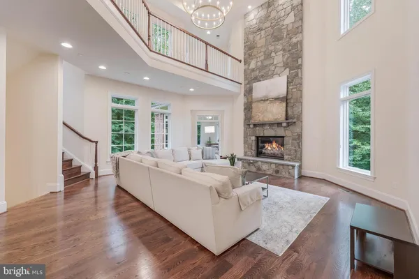 a living room with fireplace furniture and a wooden floor