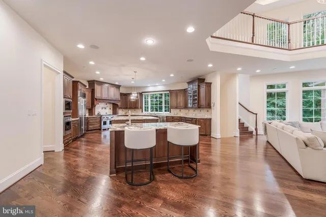 a living room with furniture and kitchen view