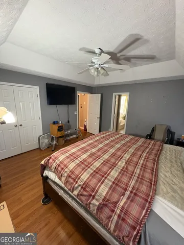 a bedroom with a large bed and a chandelier