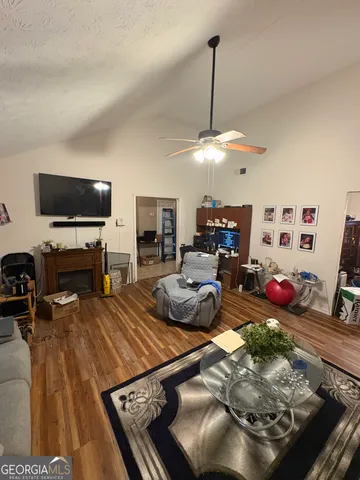 a living room with furniture and a flat screen tv