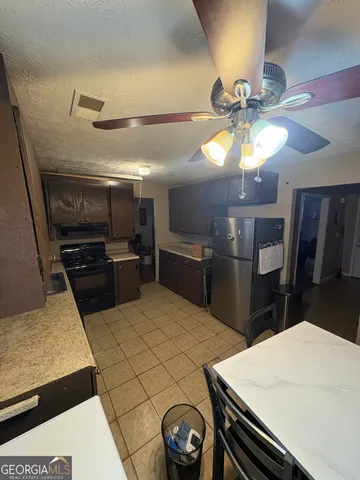 a kitchen with a stove and a refrigerator