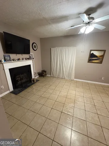 a view of a livingroom with an empty space and a fireplace