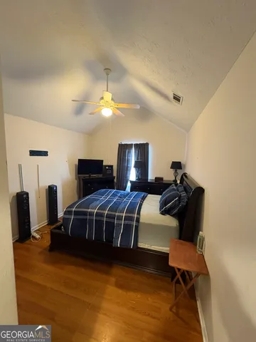 a bedroom with furniture and a mirror