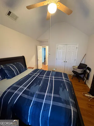 a bedroom with a bed and ceiling fan