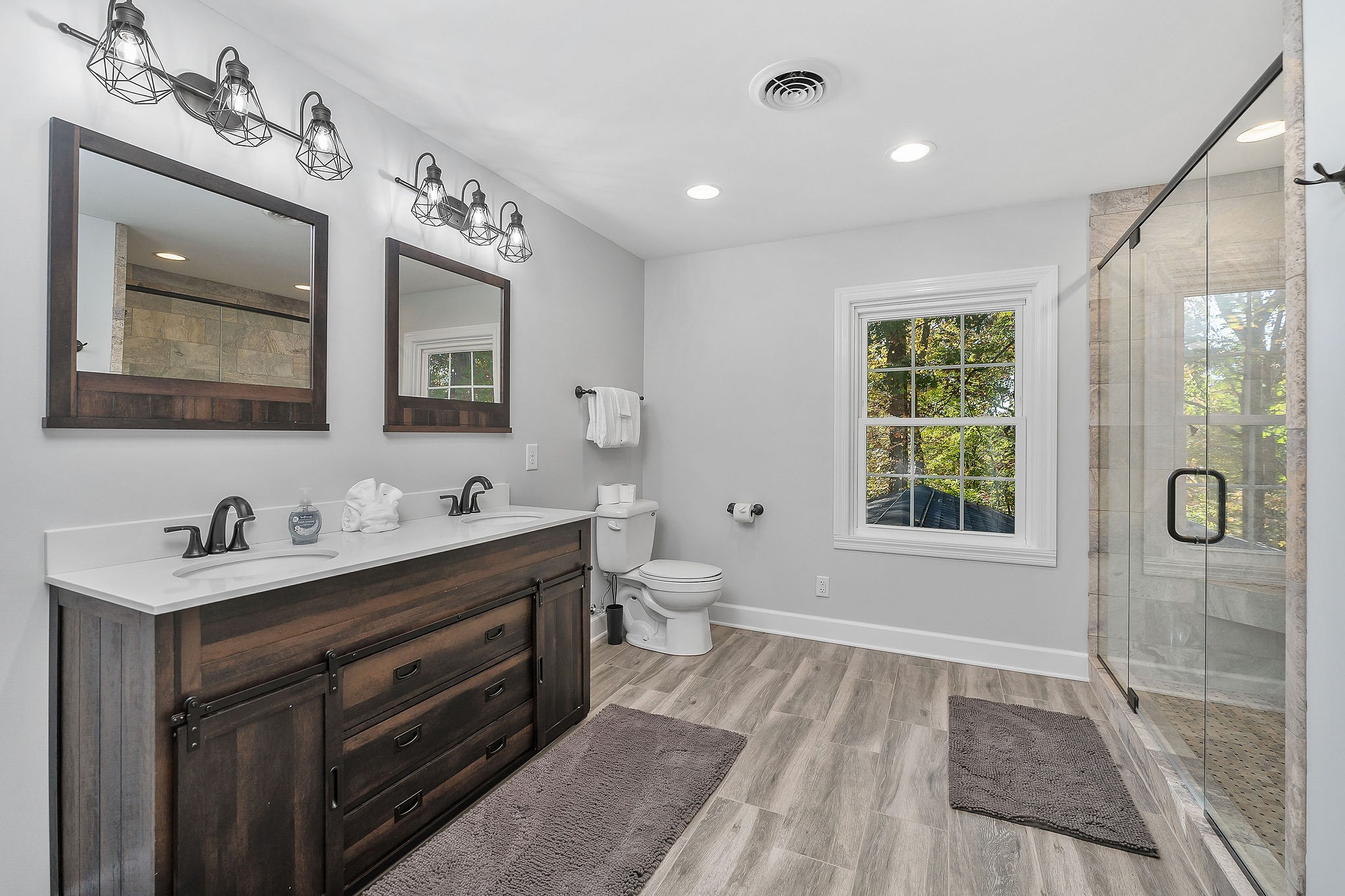 1824 Puckett Point Road Smithville, TN 37166 - Photo 41 of 53 a spacious bathroom with a double vanity sink a toilet and a mirror