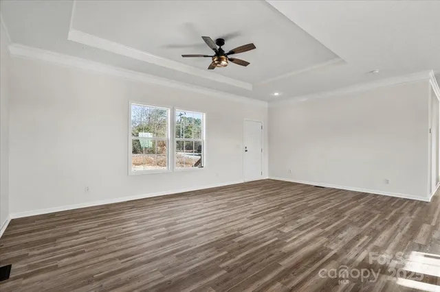 a view of a kitchen with kitchen island a sink stainless steel appliances and cabinets