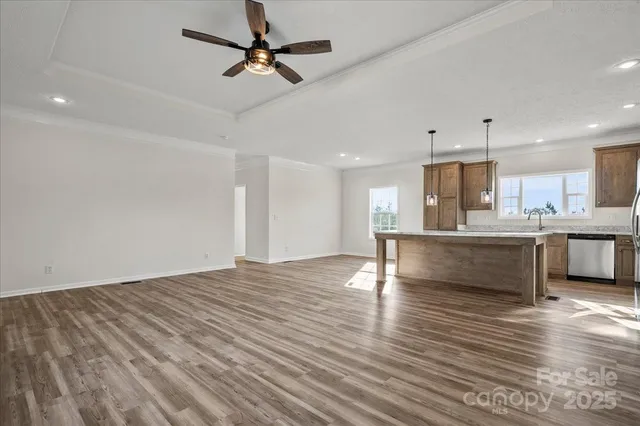 a kitchen with kitchen island a counter top space appliances and cabinets