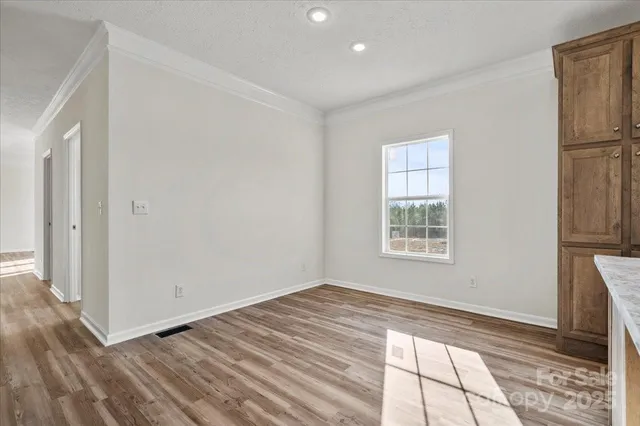 a kitchen with stainless steel appliances granite countertop a refrigerator stove top oven and sink