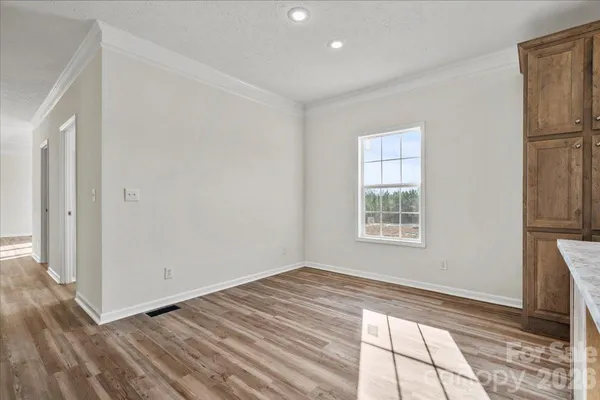 a view of room with window and wooden floor