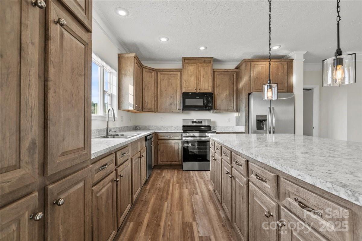 5257 Raleys Mill Road Bethune, SC 29009 - Photo 18 of 48 a kitchen with kitchen island granite countertop a sink appliances cabinets and a counter top space