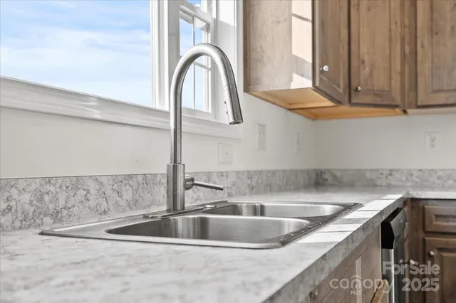 a kitchen with stainless steel appliances granite countertop a stove microwave and cabinets