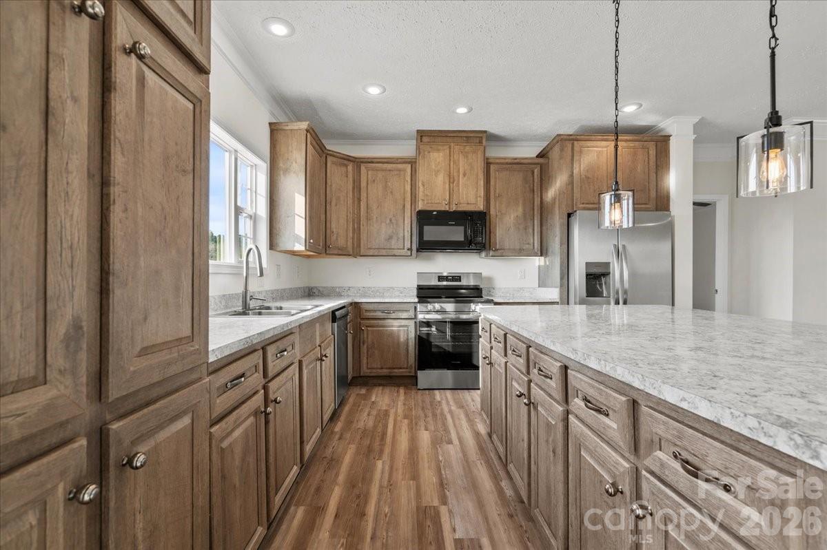 5257 Raleys Mill Road Bethune, SC 29009 - Photo 19 of 48 a kitchen with kitchen island granite countertop a sink appliances cabinets and a counter top space