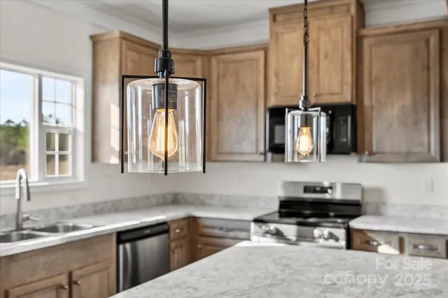 an empty room with wooden floor ceiling fan and windows