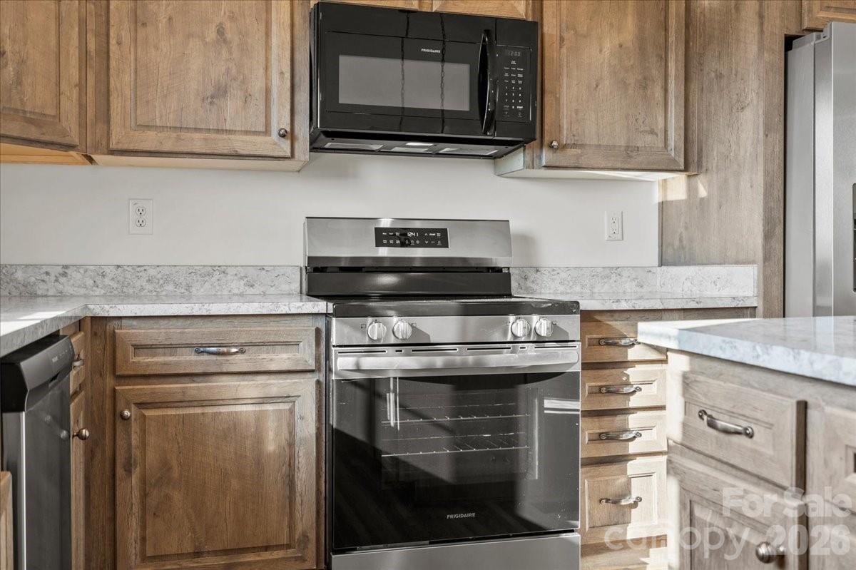 5257 Raleys Mill Road Bethune, SC 29009 - Photo 21 of 48 a kitchen with stainless steel appliances granite countertop a stove microwave and oven