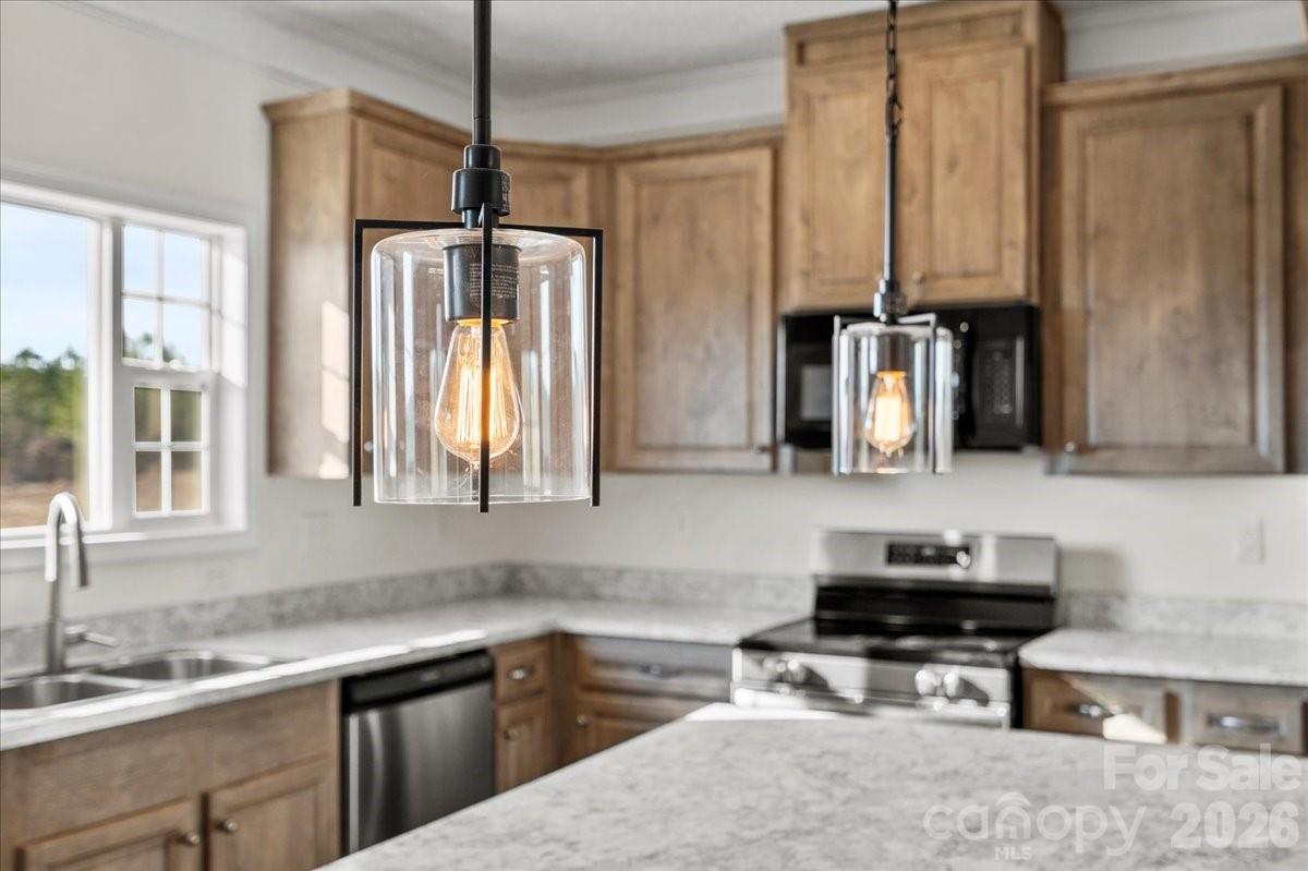5257 Raleys Mill Road Bethune, SC 29009 - Photo 22 of 48 a kitchen with stainless steel appliances a sink stove and cabinets