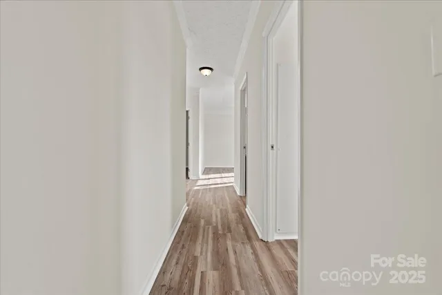 a view of room with window and wooden floor